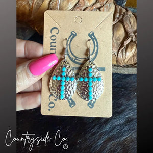Hammered silver cross earrings with turquoise stones.