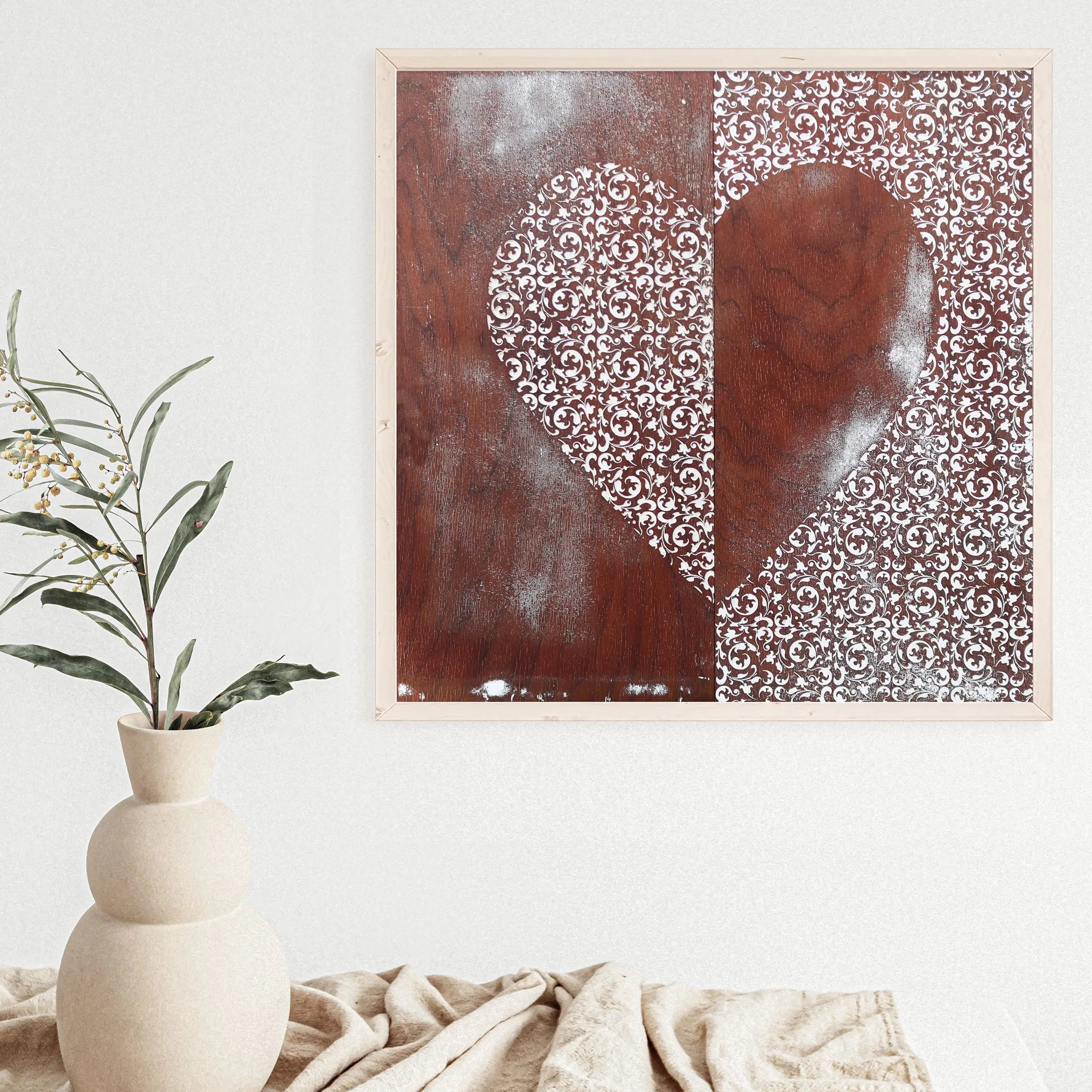 Heart art print with white filigree pattern on dark wood.