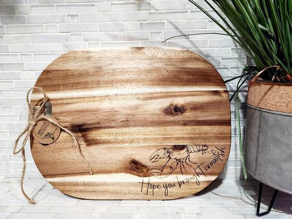 Wooden serving tray with crawfish design and 'Hope you brought crawfish' inscription.