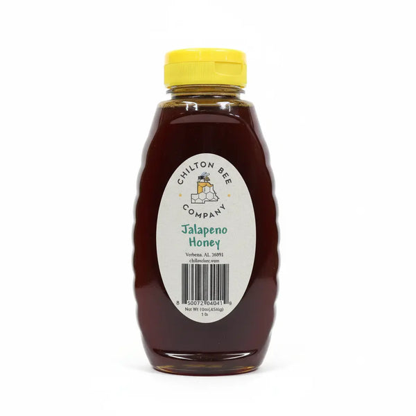 Bottle of Chilton Bee Company Jalapeno Honey with a yellow lid and a label, on a white background.