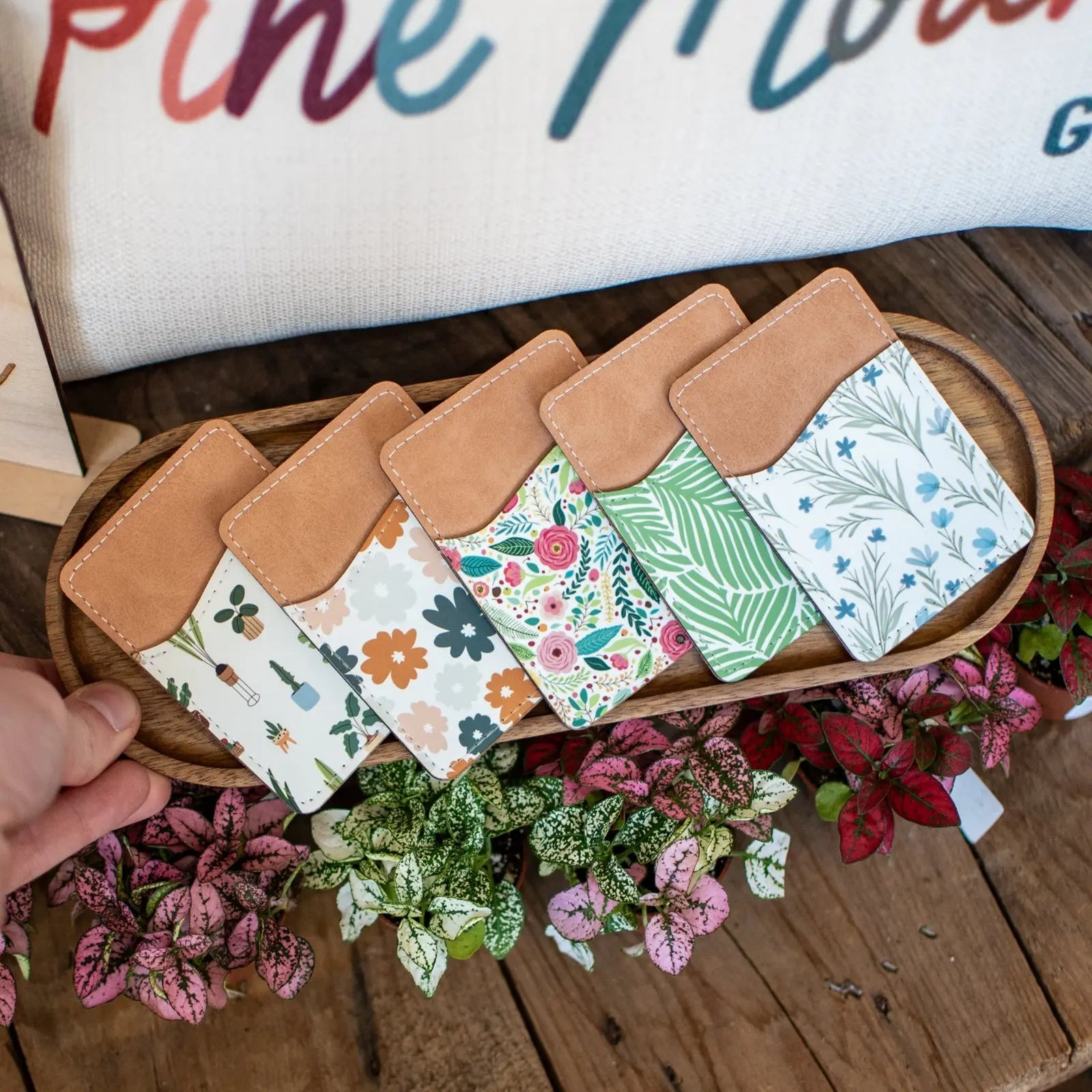 Phone wallet with houseplant patterns and tan leather top
