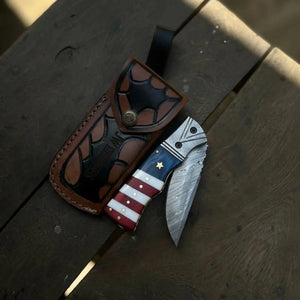 Damascus Folding Pocket Knife — American Flag Handle, Damascus Bolster, Linear Lock & Hand Engraved Leather Sheath
