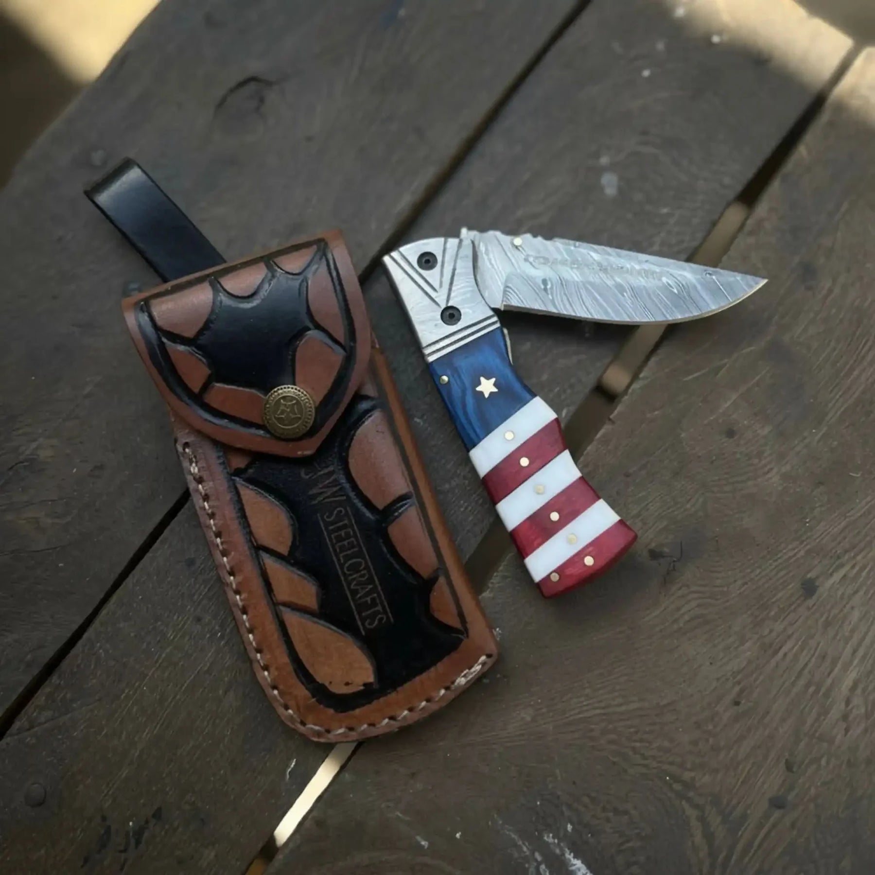 Damascus Folding Pocket Knife — American Flag Handle, Damascus Bolster, Linear Lock & Hand Engraved Leather Sheath