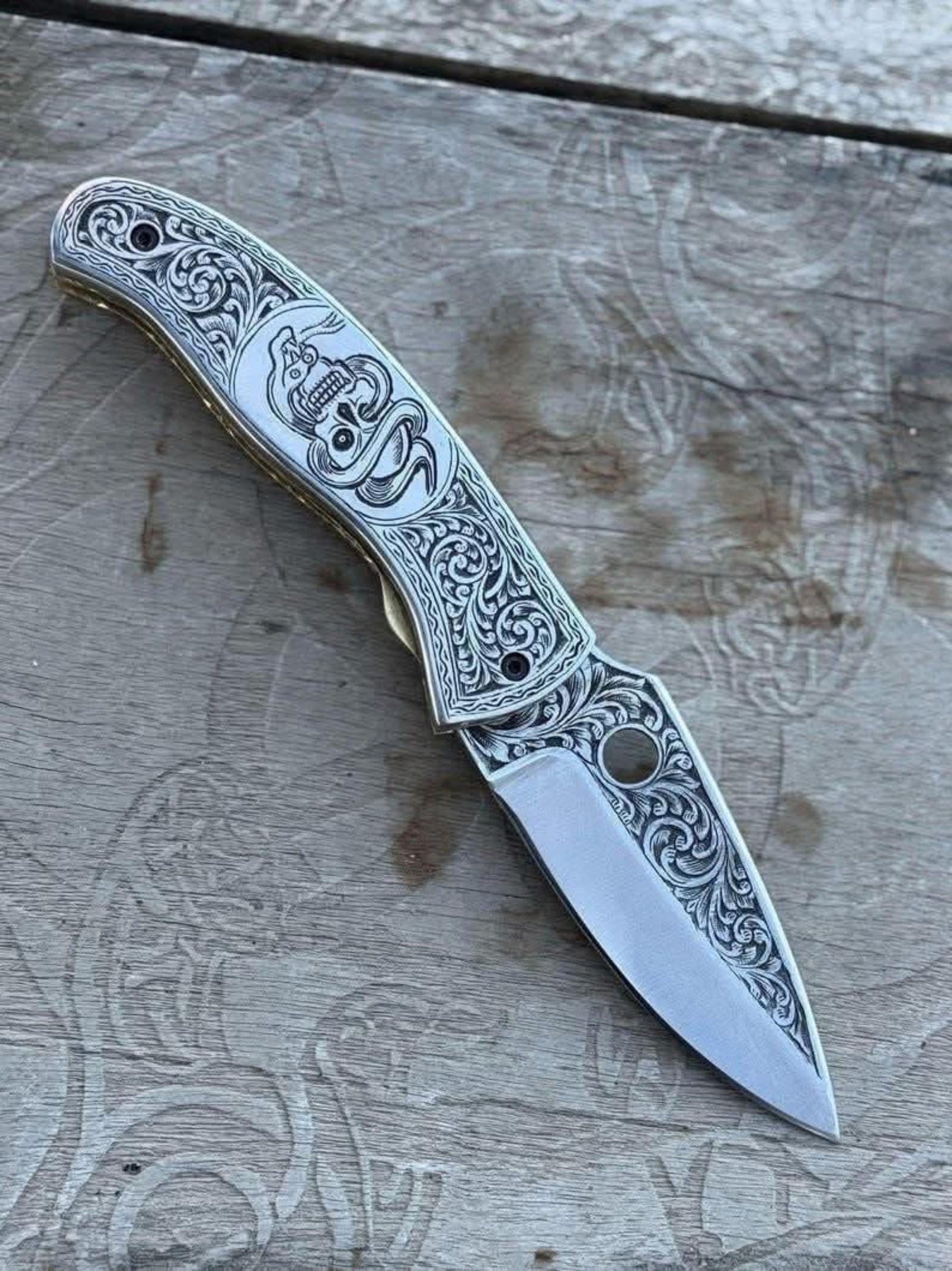 Engraved Scrollwork Folding Knife with Silver Finish and Detailed Blade Etching