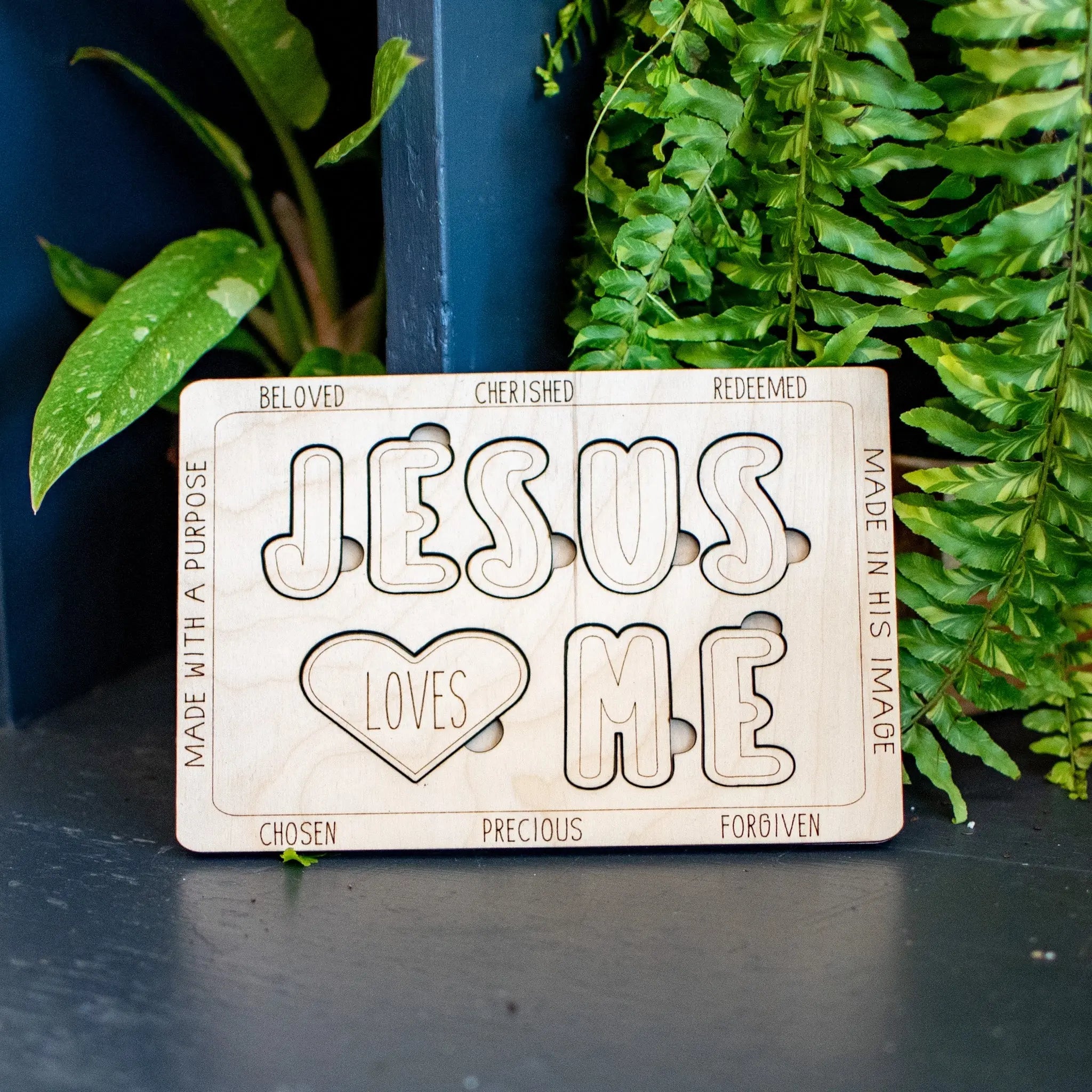 Wooden "Jesus Loves Me" puzzle with block letters and a heart shape.
