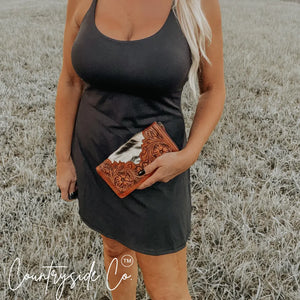 Countryside Co. Juliet tooled leather and cowhide western wallet held by a person.
