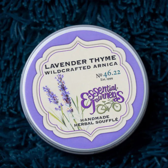Round tin of Lavender Thyme Arnica Soufflé with purple and cream label.