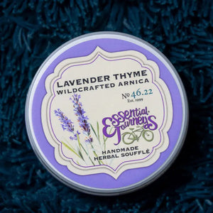 Round tin of Lavender Thyme Arnica Soufflé with purple and cream label.