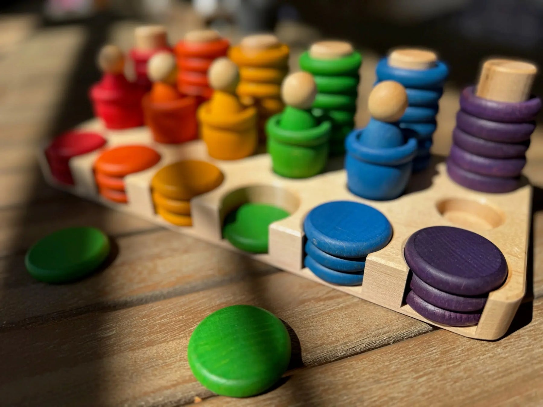 Maple sorting tray with colorful stacked discs for Grapat Carla.