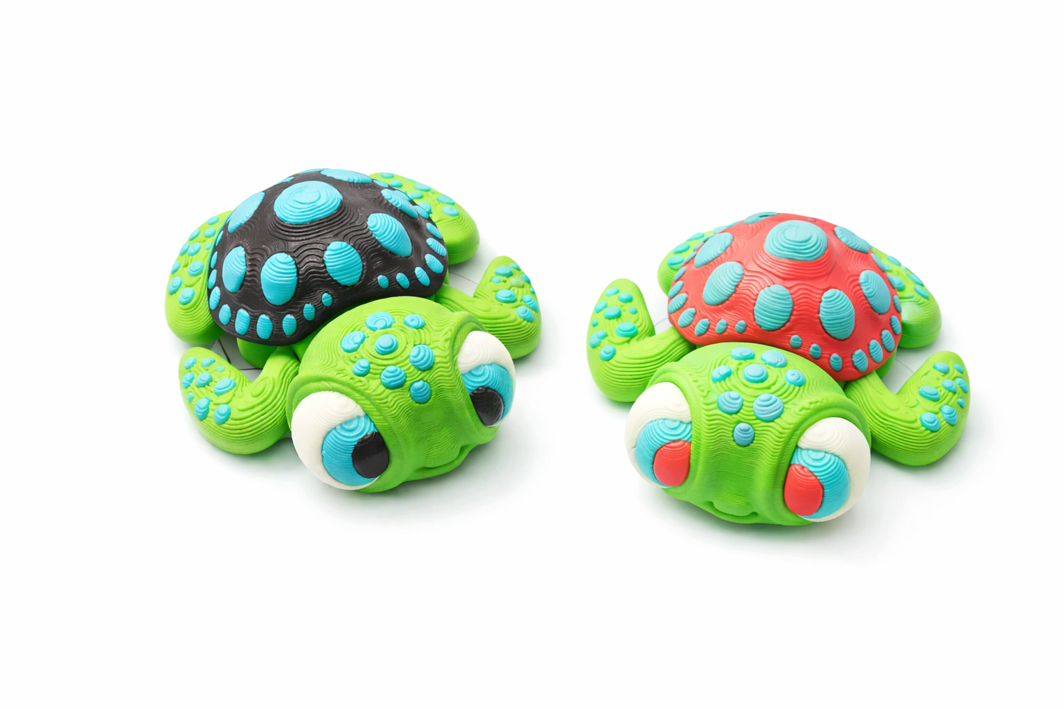Articulated fidget turtle toys: black/blue & red/blue shells, green bodies, on white.