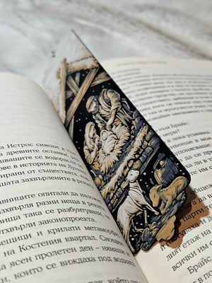 Nativity Scene Bookmark: A detailed Christmas scene on a bookmark inside a book, featuring Mary, Joseph, and baby Jesus.