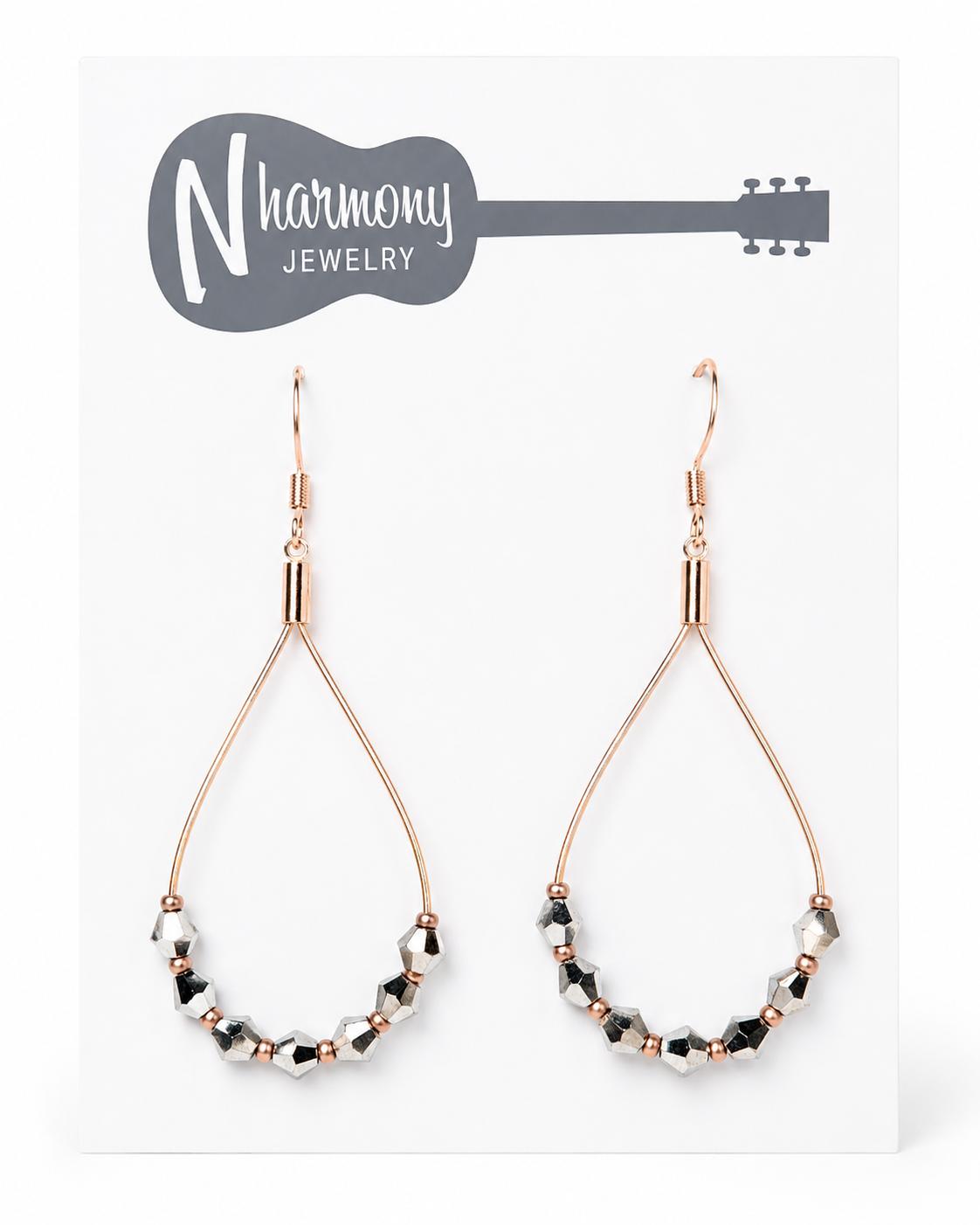 Teardrop-shaped earrings with beaded design on a NHarmony Jewelry card.