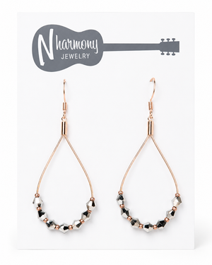 Teardrop-shaped earrings with beaded design on a NHarmony Jewelry card.