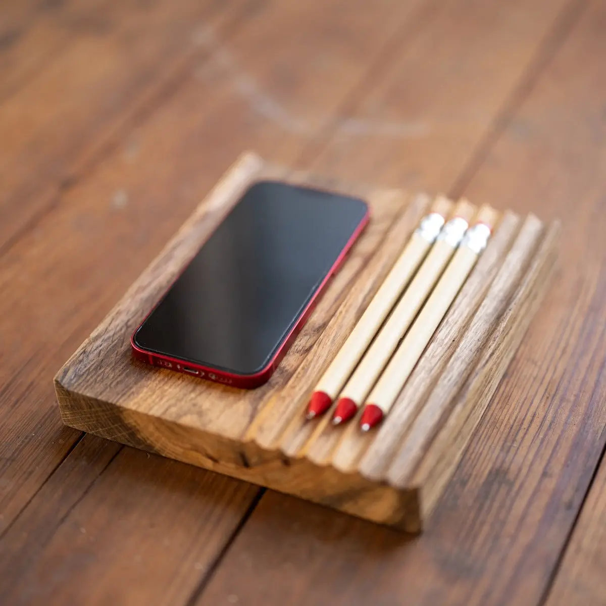Oak Phone and Pen Tray on a wooden desk organizer, featuring a phone and three pens.