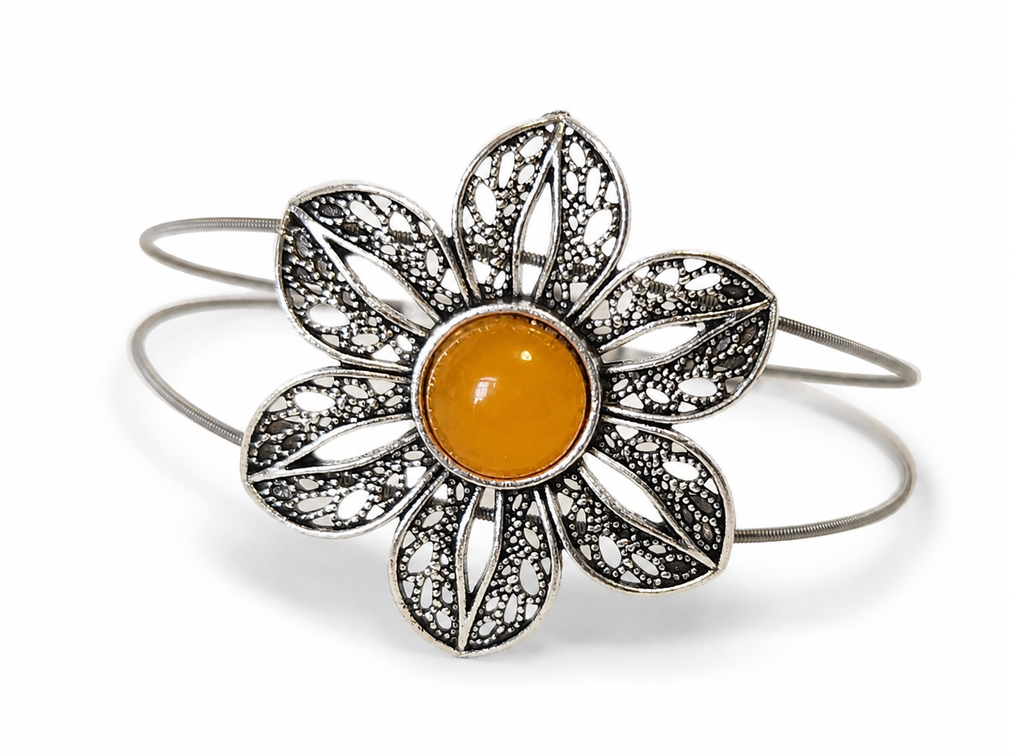Silver flower-shaped bracelet with a yellow center on a white background
