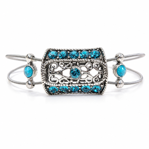 Silver bracelet with turquoise gemstones on a white background