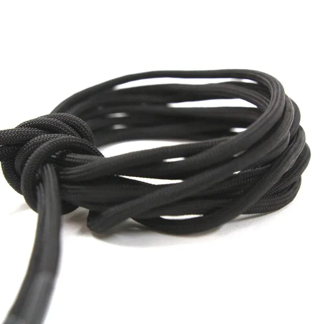 Black paracord boot lace coiled with a knot
