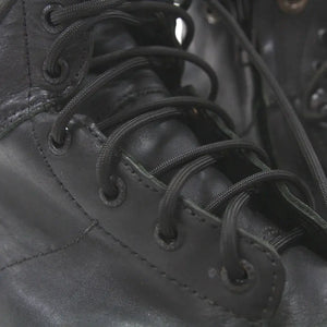 Black paracord boot laces threaded through eyelets on a black boot.