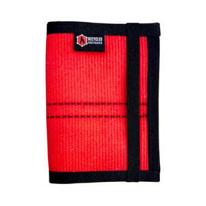 Red recycled firefighter hose passport wallet with black elastic strap and logo