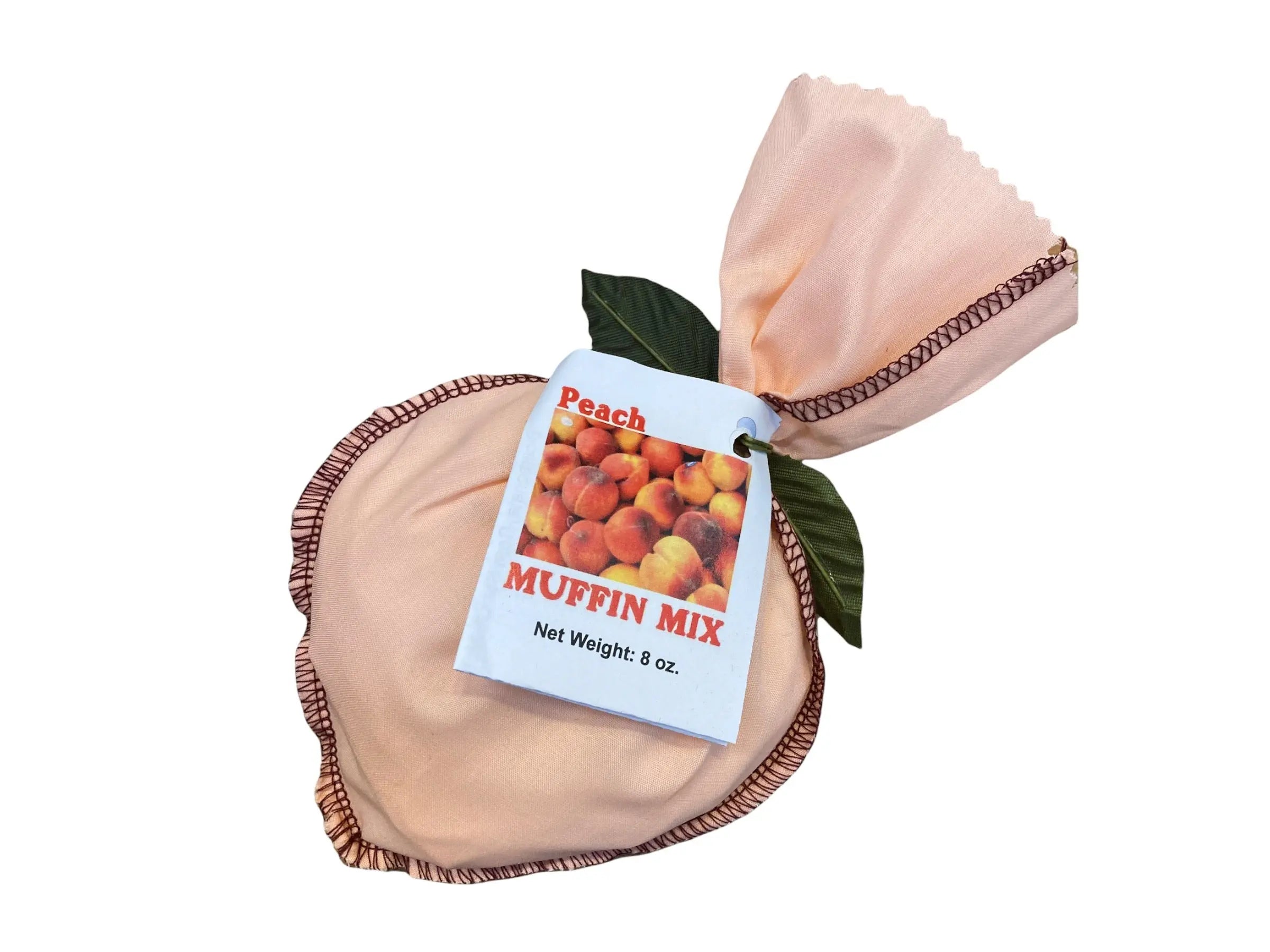 Peach muffin mix in a fabric pouch with a label showing peaches.