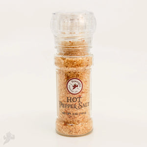 Clear plastic grinder filled with coarse hot pepper salt