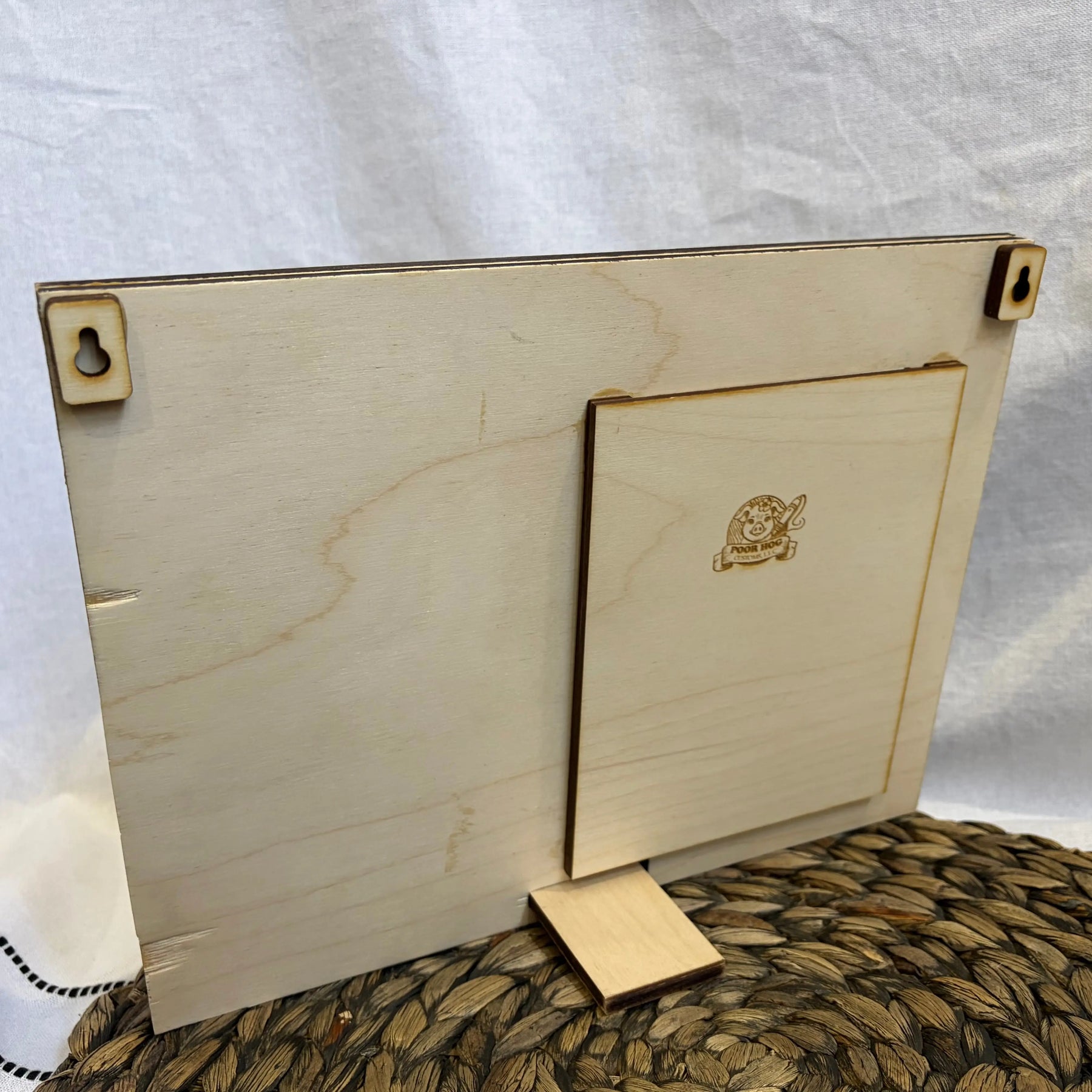 Personalized wooden picture frame with love quote and photo space, showcasing its desktop stand and hanging hardware.