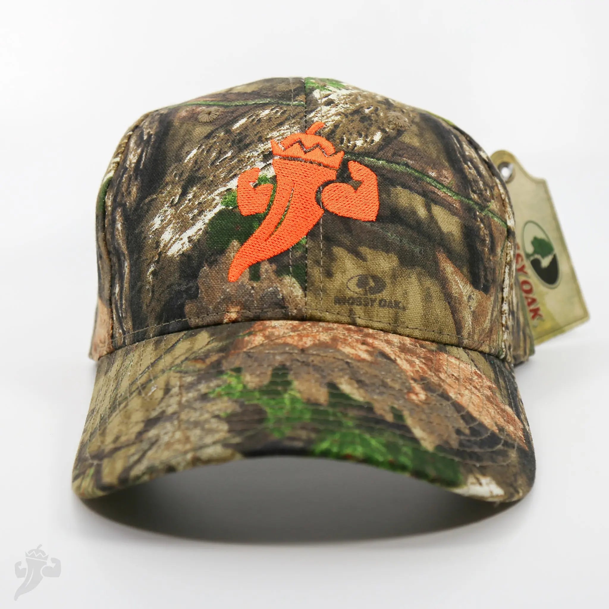 Camo baseball cap with embroidered orange pepper logo and Mossy Oak tag.
