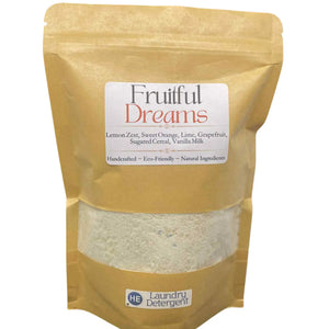 Pouch of laundry detergent with label stating "Fruitful Dreams" and a clear window showing the powder.