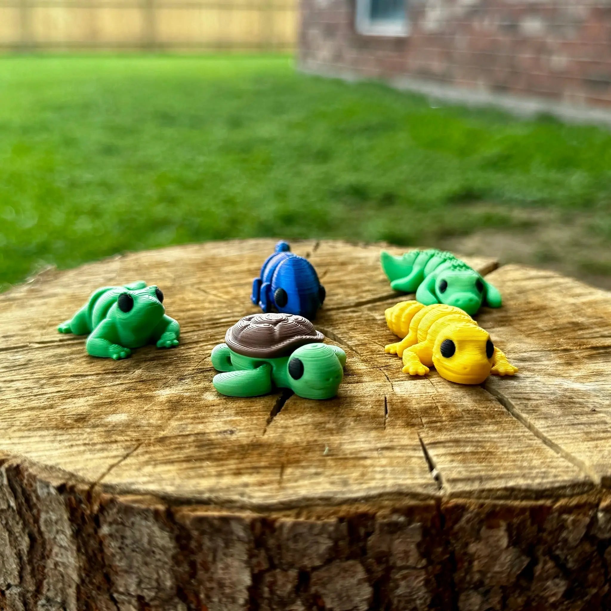 Reptile Rascals Fidgets by Main Street Collective: 3D printed turtle, frog, lizard, alligator, chameleon, and gecko on a tree stump