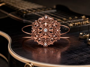 Decorative rose gold bracelet with gemstones on a guitar