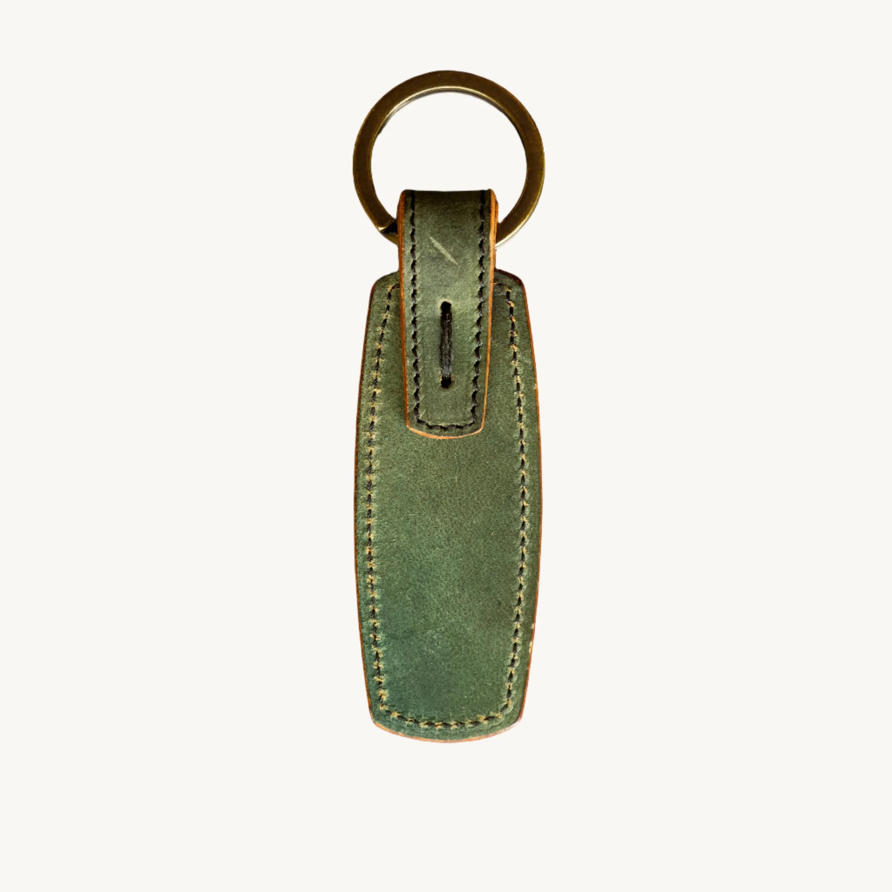 Green leather key ring with antique brass ring from Main Street Collective, featuring hand-stitched Horween Shell Cordovan.