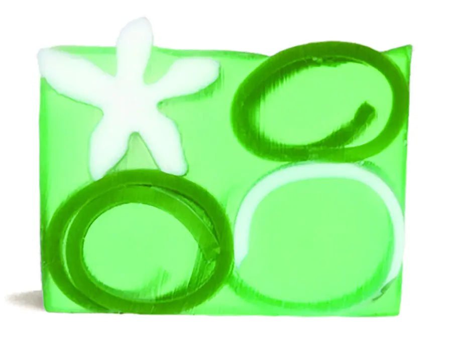 Green bar soap with white flower and green ring designs, clear jelly texture.