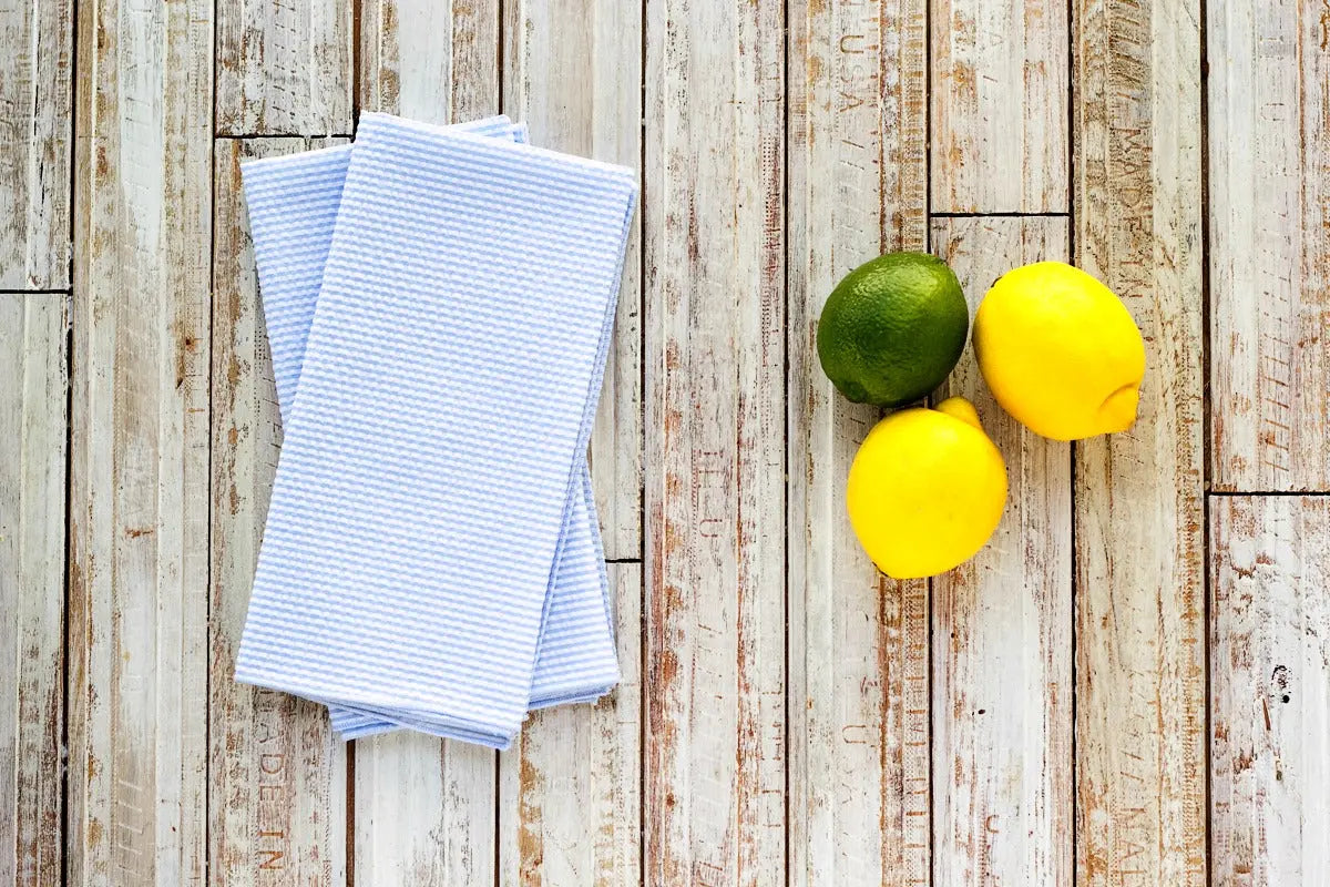 Seersucker napkins with lemons and lime on a wood background