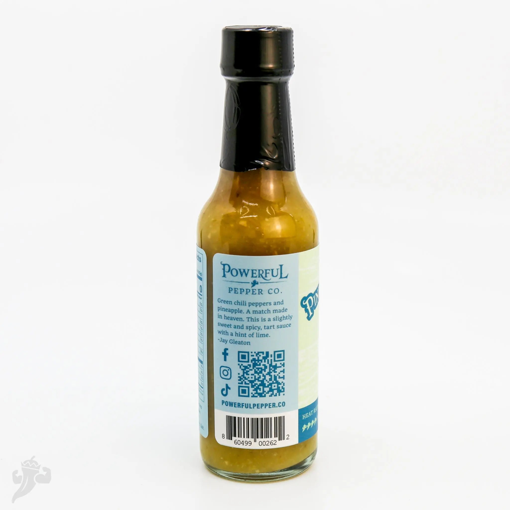 Serrano Pineapple Hot Sauce from Powerful Pepper Co. featuring green chili peppers.