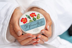 The Farmers Garden hand cream with calendula and nasturtium flowers on the label.