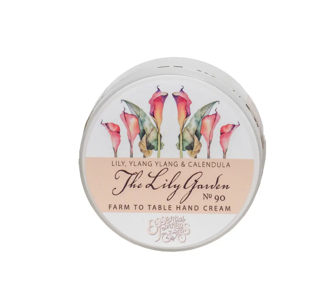 Round tin of The Lily Garden hand cream with floral art and text.