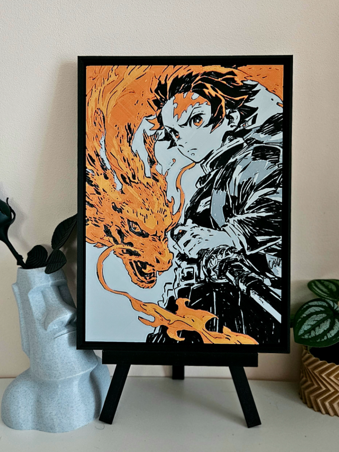 Demon Slayer filament art: Tanjiro Kamado using Hinokami Kagura, framed anime wall art with dragon-like fire, displayed on a stand.