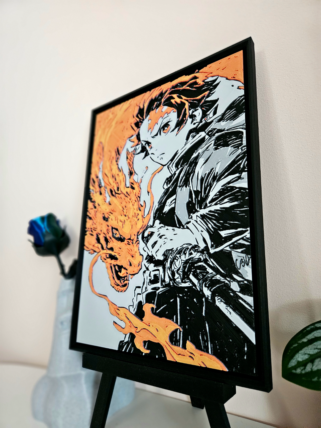 Tanjiro from Demon Slayer filament painting on a stand, featuring a dragon-like fire effect in orange and black.