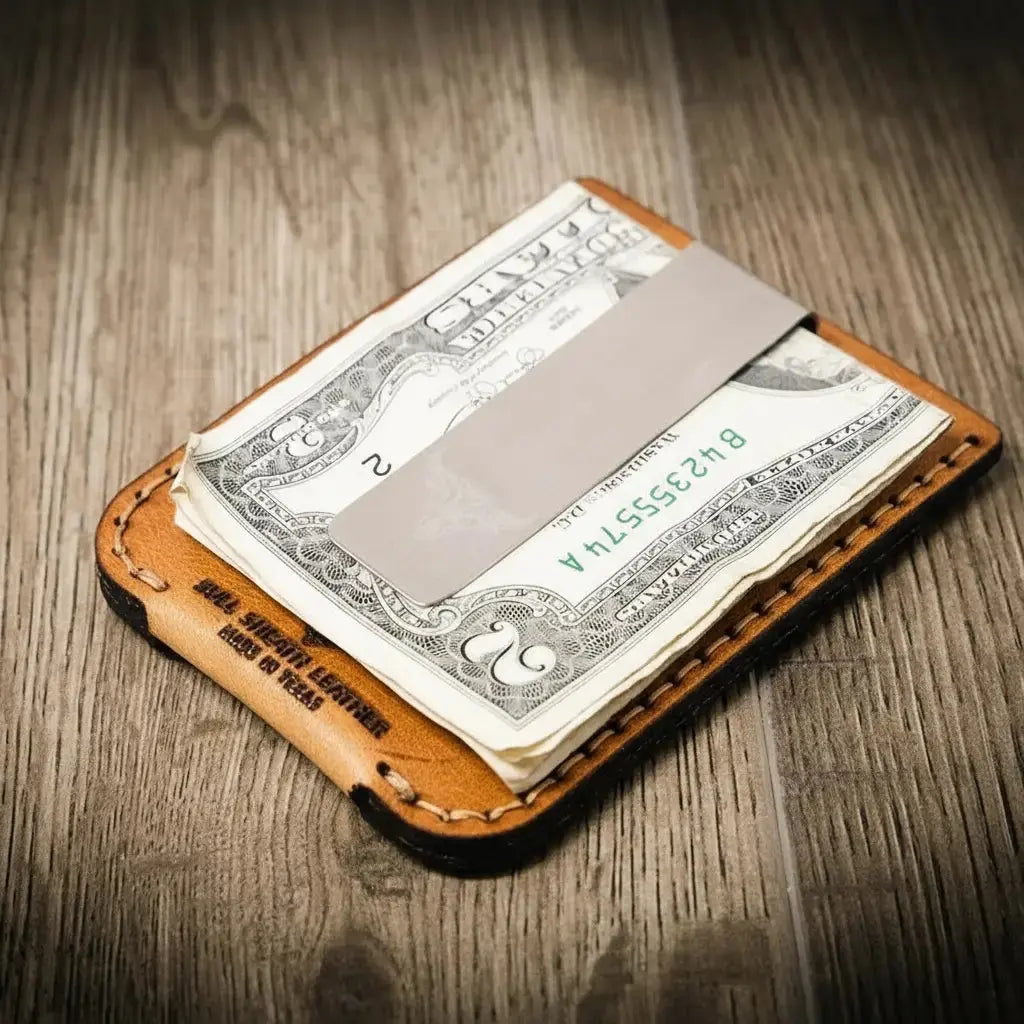Brown leather money clip wallet with US dollar bills and a metal clip.