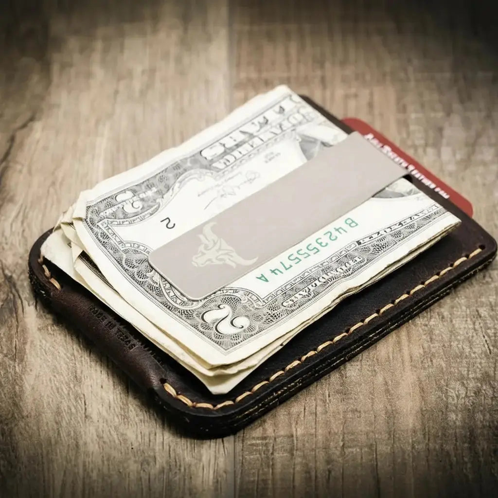 Brown leather money clip wallet with US dollar bills and metal clip