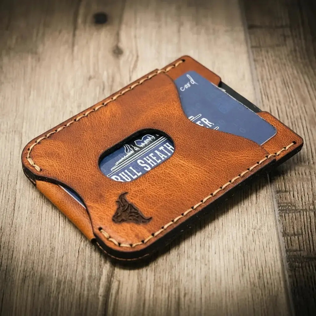 Brown leather money clip wallet with card slots and embossed bull logo.