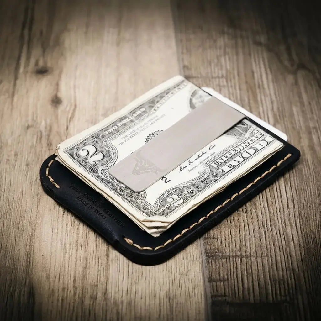 Black leather money clip wallet holding folded dollar bills and a metal clip.