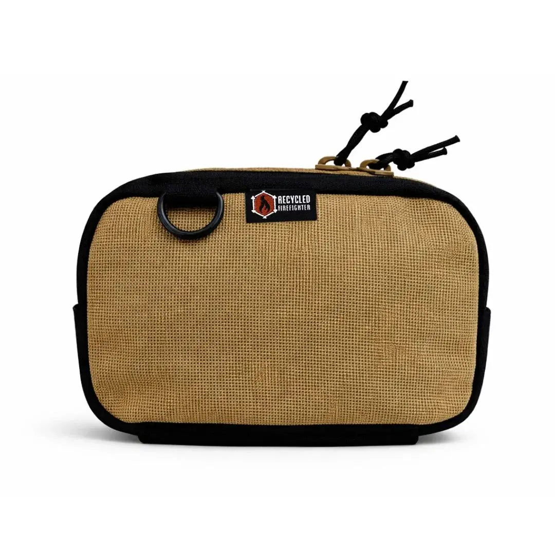 Tan canvas fanny pack with black trim and D-ring