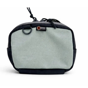 Black and gray Cordura fanny pack with D-ring and drawstring detail.