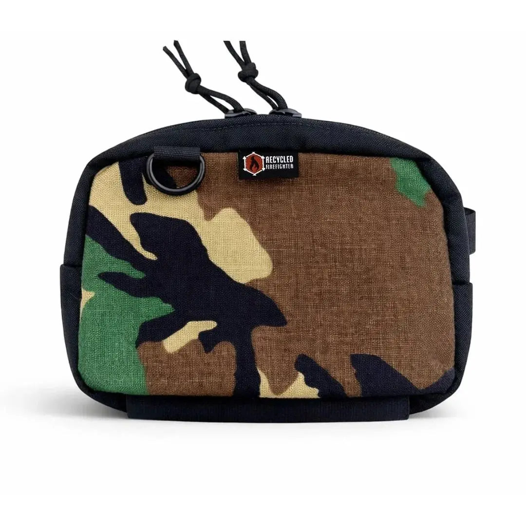 Camouflage fanny pack with black trim and zipper pulls