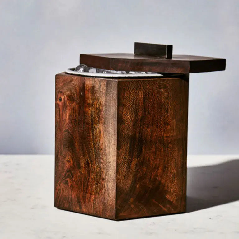 Blackened cherry wooden ice bucket with stainless steel insert and lid partially open on a white surface.