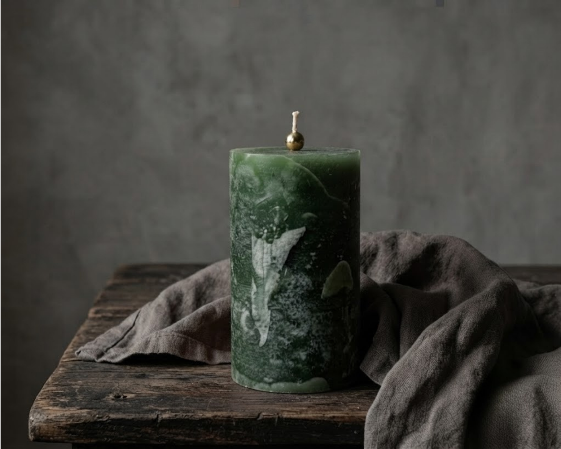 Forest green textured pillar candle by Believe Candle shown upright