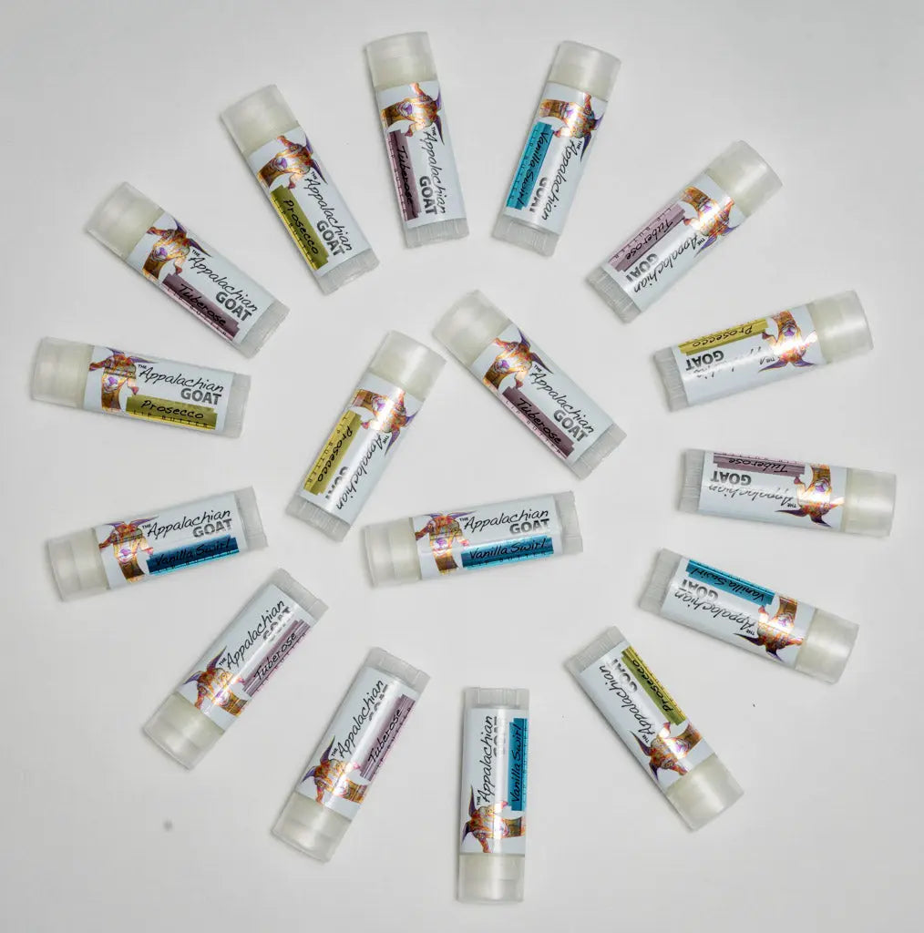 Assortment of Appalachian Goat vanilla swirl lip balm tubes arranged on a white background.