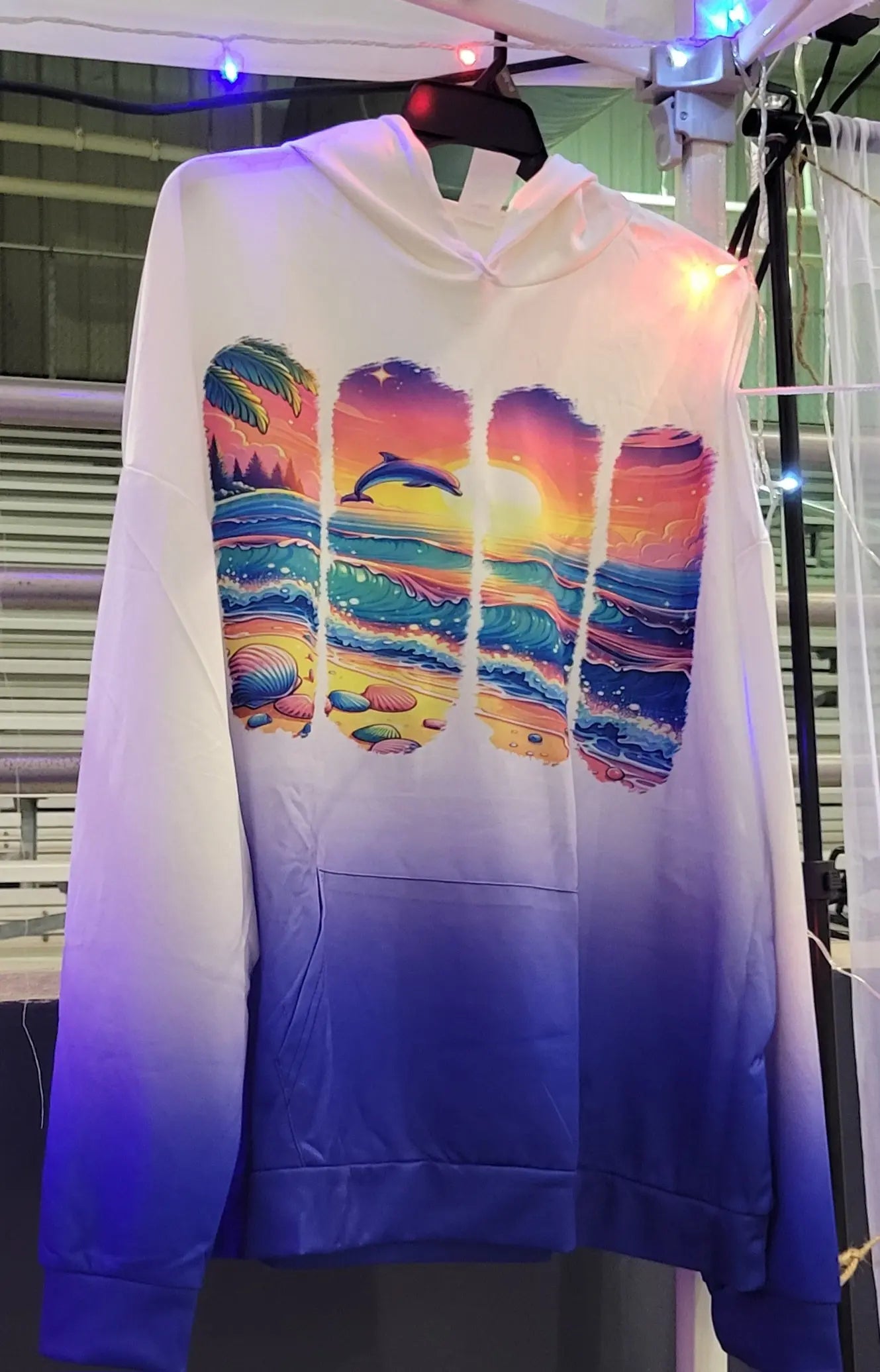 Variegated hoodie featuring a dolphin beach scene, size 3XL, with blue to white gradient.
