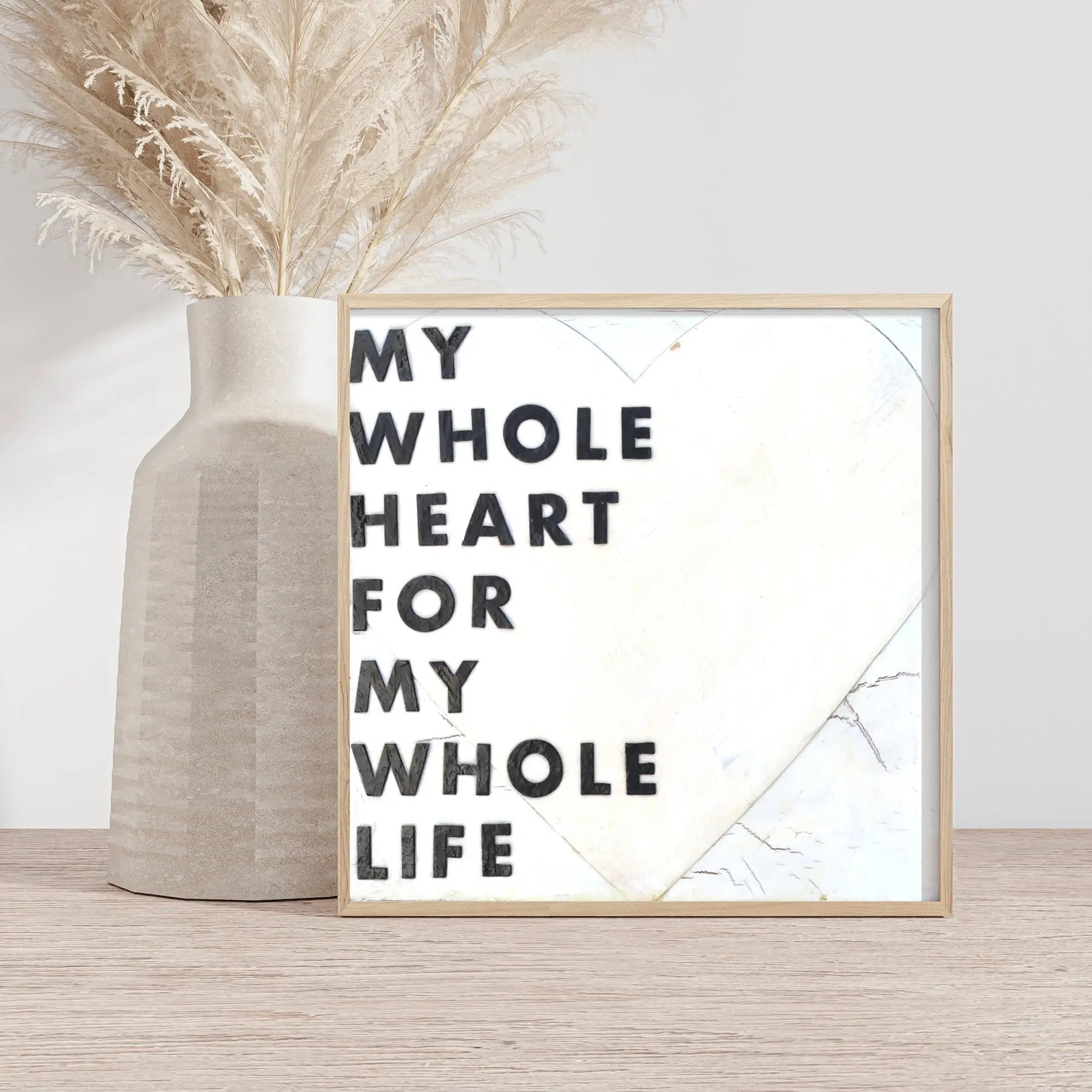 Framed "My Whole Heart For My Whole Life" quote art print with heart graphic beside a vase.